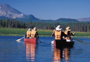 Mt. Bachelor provides a spectacular backdrop  to canoeists paddling in Hosmer Lake near Bend, Ore.  Photo by Christian Heeb/Wanderlust Tours